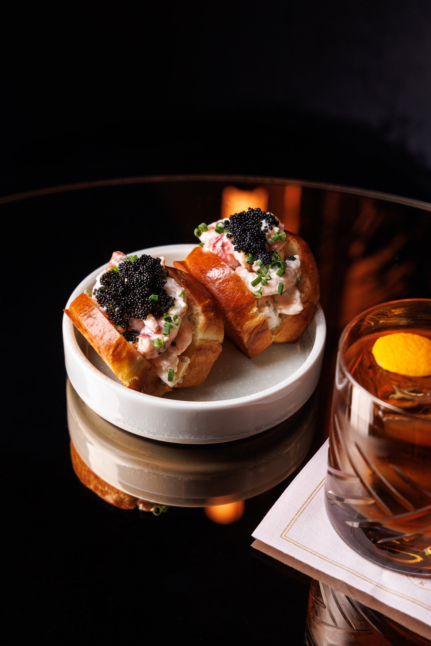 Lobster rolls and a cocktail served at Fairmont Royal's lobby bar, Clockwork.