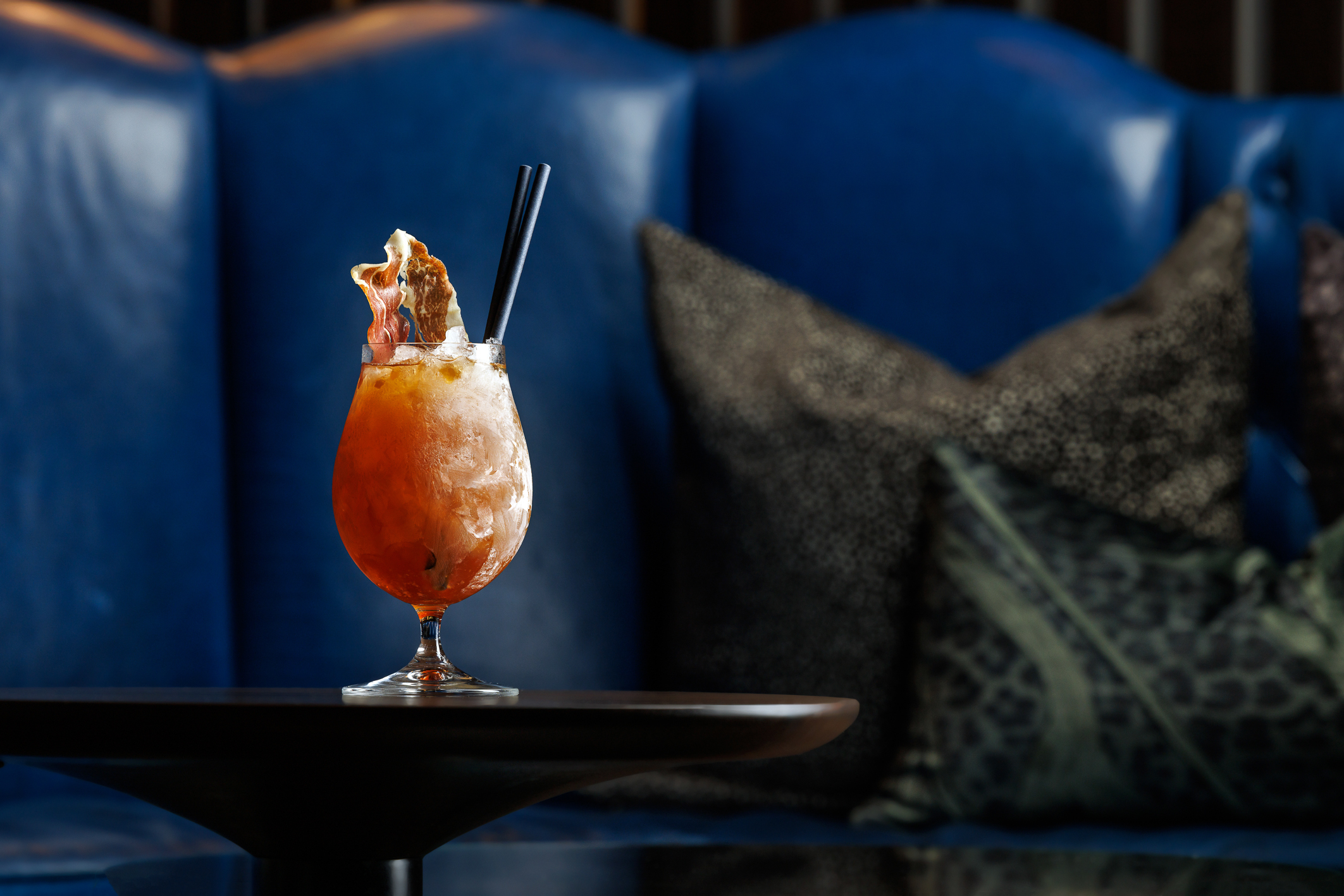 An icy cocktail with a cured meat garnish.