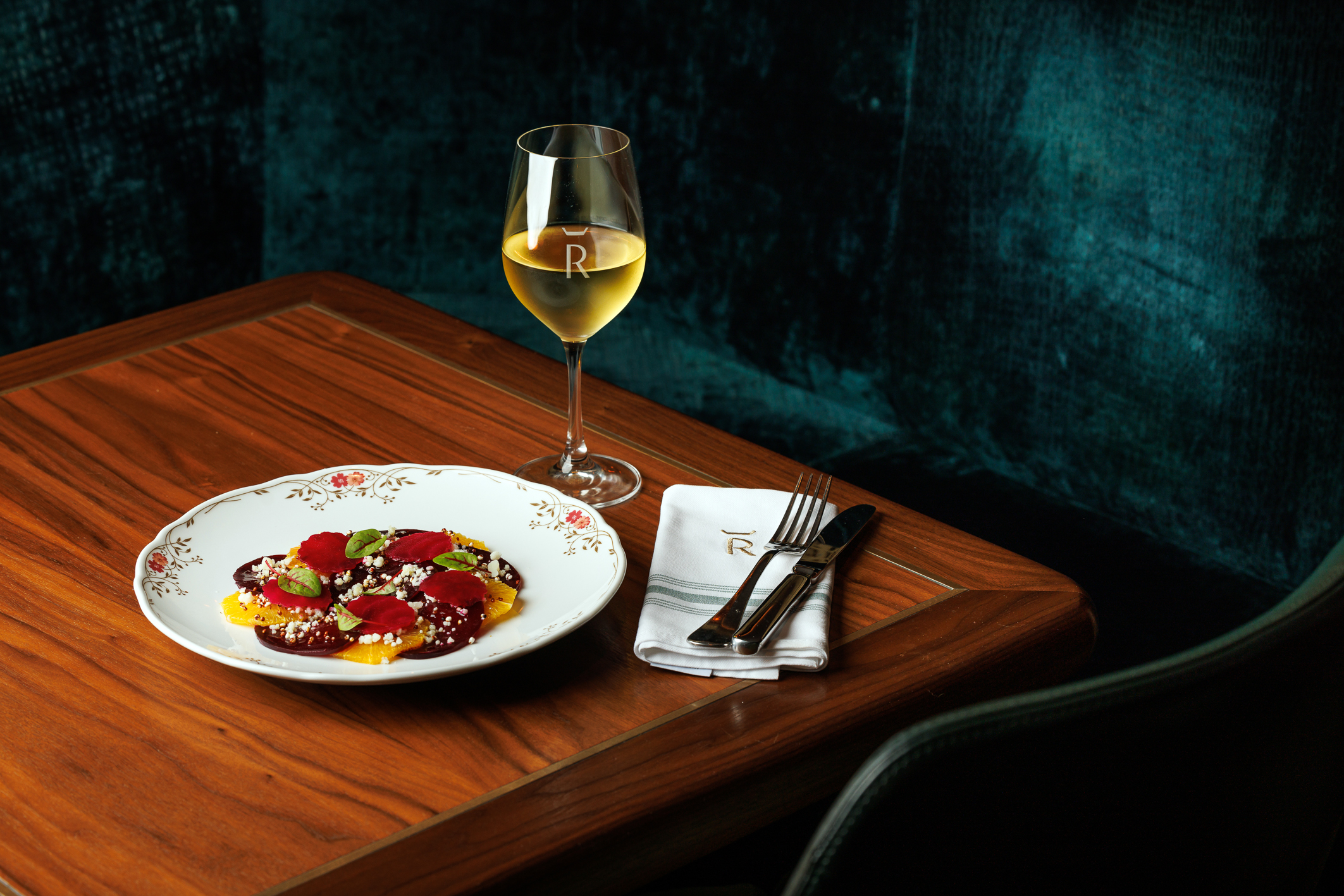 A delicate salad and white wine served at Reign Restaurant, Bar & Bakery in Toronto.