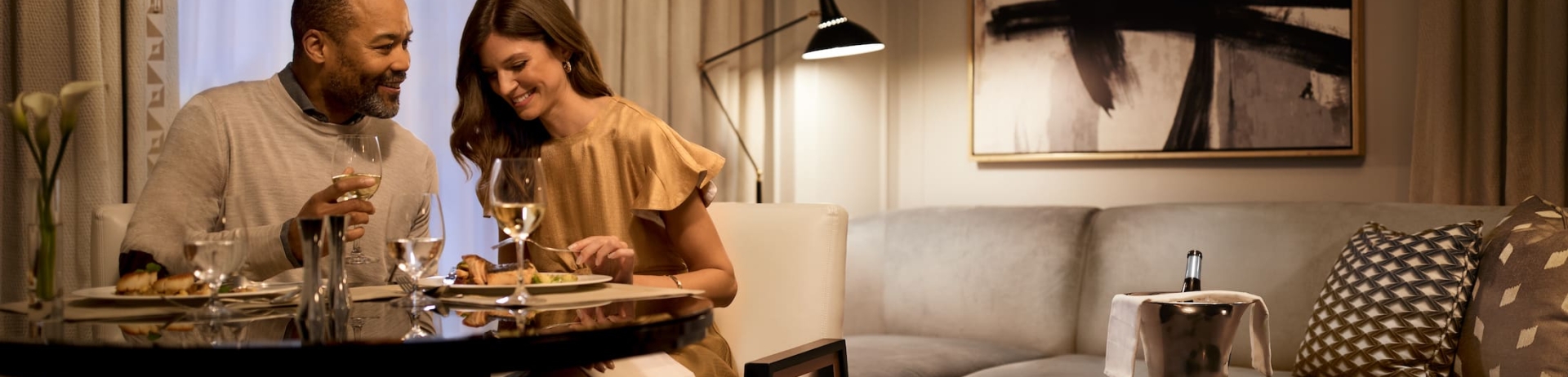 Two guests enjoying in-room dining in their Fairmont Royal York Hotel suite.