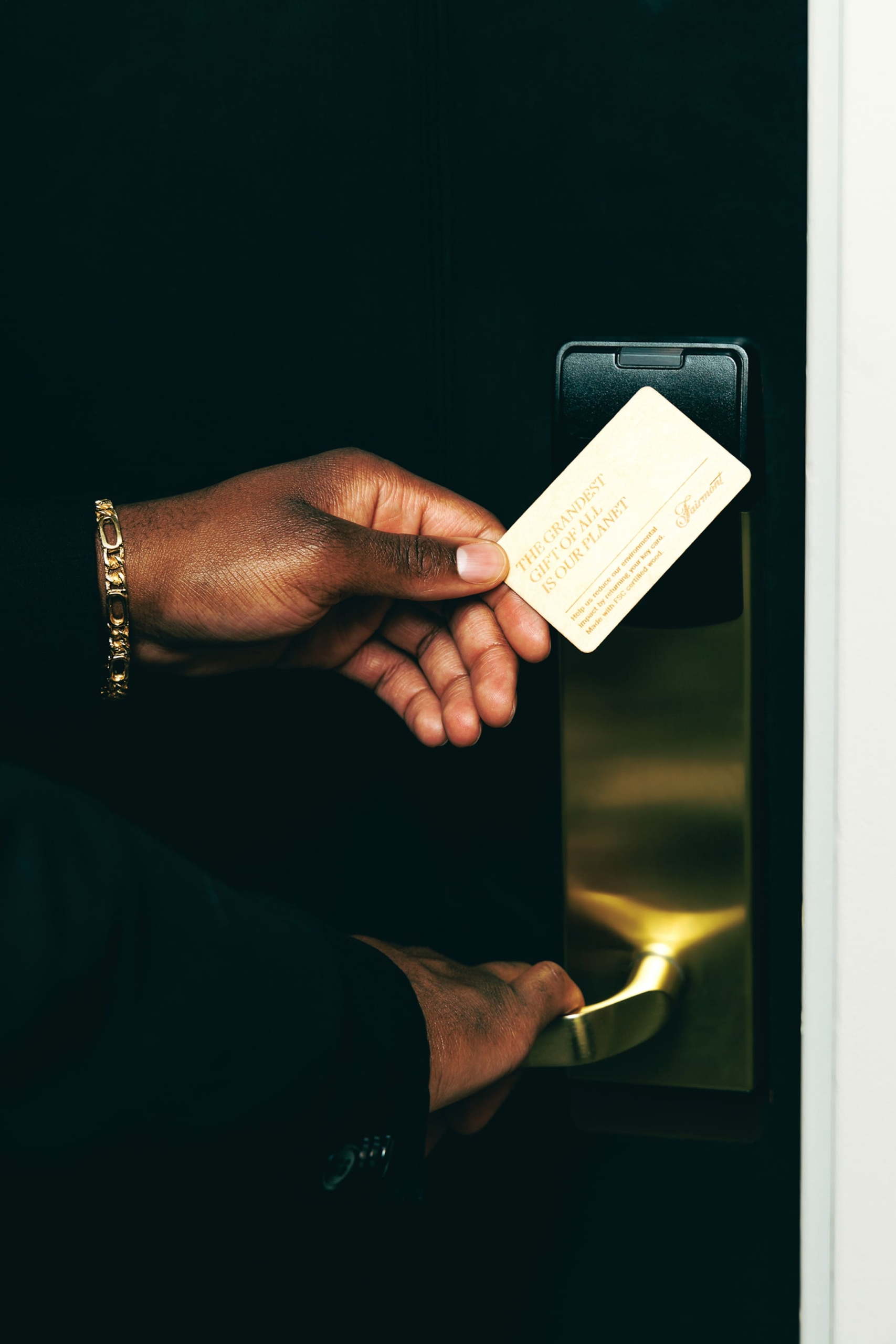 A hand using a keycard to open a suite door at Fairmont Royal York Hotel in Toronto.